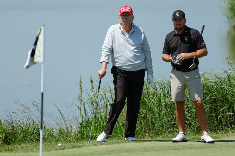 Mr Trump and professional golfer Graeme McDowell. Reuters
