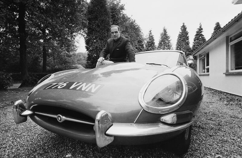 British automobile designer Roy D. Haynes, who designed the 1966 Ford Cortina MkII, after his move to the BMC, UK, 20th October 1967. He is pictured with an E-type Jaguar. (Photo by Les Lee/Daily Express/Getty Images)