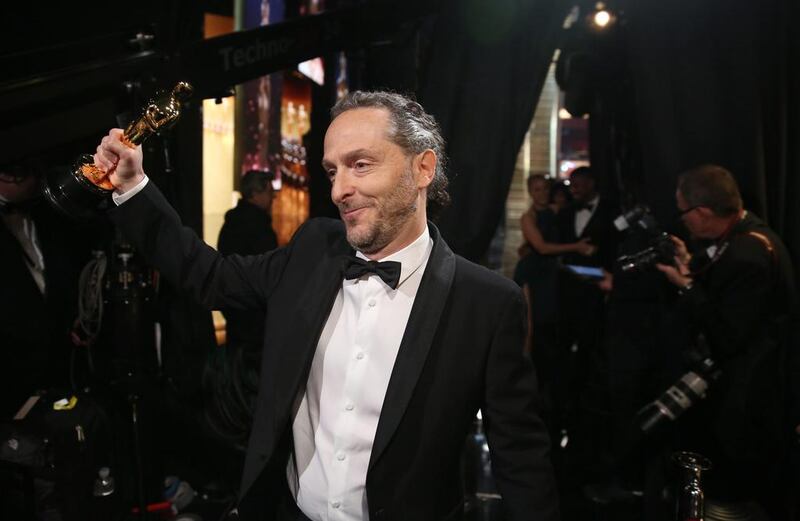 Emmanuel Lubezki appears backstage with the award for best cinematography for The Revenant. AP