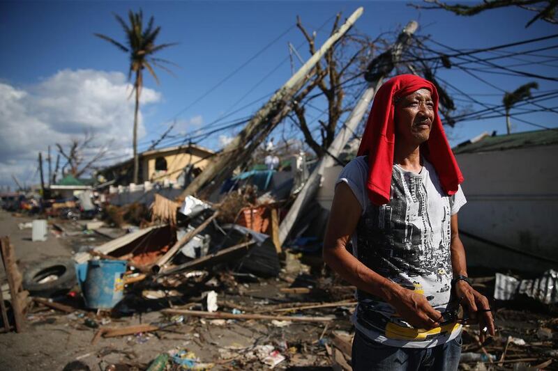 A man walks by a demolished street in Leyte, Philippines. Countries all over the world have pledged relief aid to help support those affected by the typhoon but damage to the airport and roads have made moving the aid into the worst-affected areas very difficult. Dan Kitwood / Getty Images 