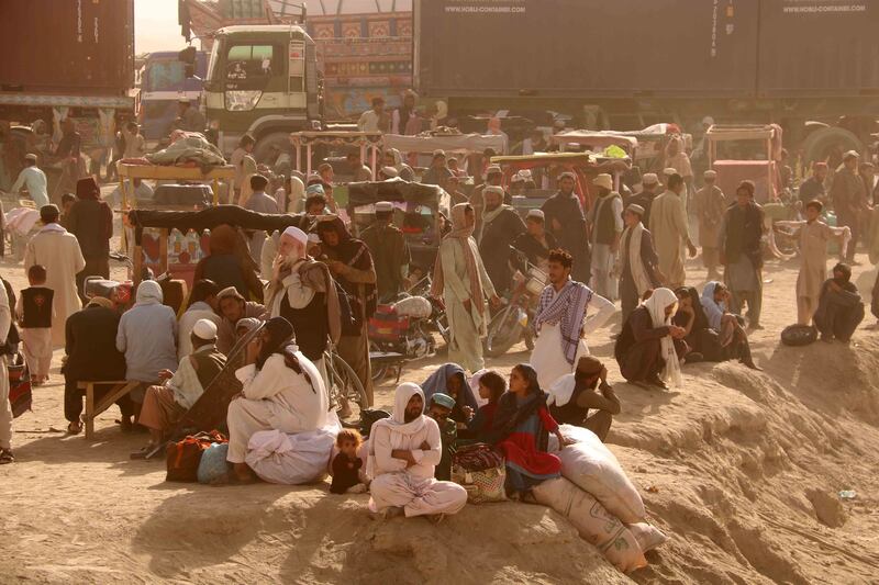  People stranded at the Pakistani-Afghan border wait for its reopening after it was closed by the Taliban who have taken over the control of the Afghan side of the border at Chaman, Pakistan, 05 October 2021. Taliban authorities have closed their side of the Afghan border for an indefinite period demanding the Pakistani authorities for making the process easier for Afghans who wants to cross into Pakistan through Chaman border.   EPA / AKHTER GULFAM