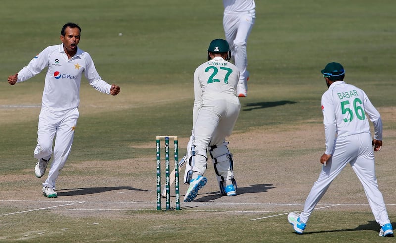 Pakistan's spinner Nauman Ali, left, celebrates after taking the wicket of South Africa's George Linde. AP