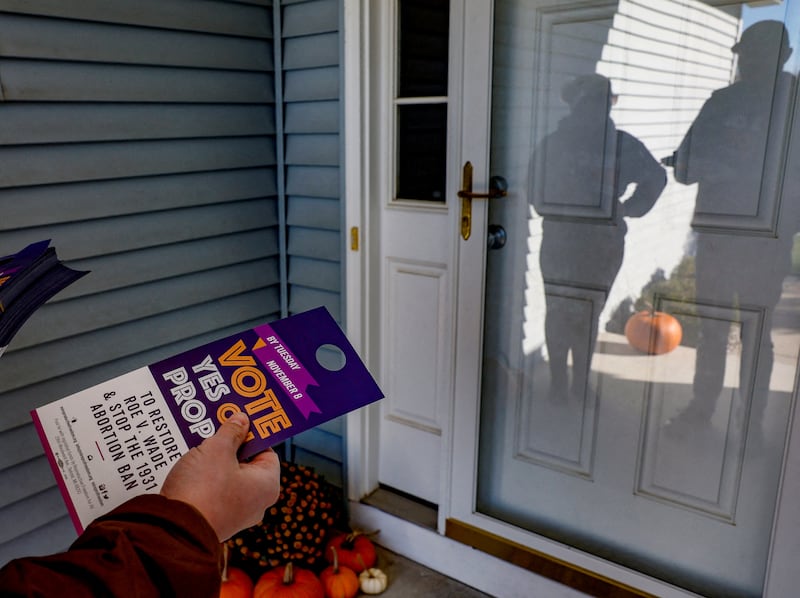 Morgan Koetje and Nickolas Lentz from Reproductive Freedom for All, canvass a neighborhood in support of Proposal 3, a ballot measure that would codify the right to an abortion, one day before the midterm election in Dewitt, Michigan. Reuters