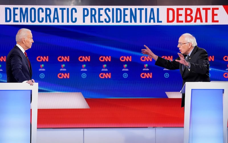 Former Vice President Joe Biden listens as Senator Bernie Sanders speaks during the 11th Democratic candidates debate of the 2020 US presidential campaign, held at CNN's Washington studios. Reuters