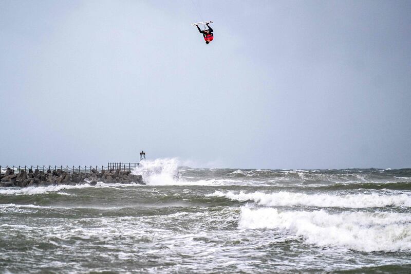 A competitor turns upside down during the Big Air kitesurfing contest in the North Sea near Vorupoer in Denmark, on Thuursday, September 23. AFP