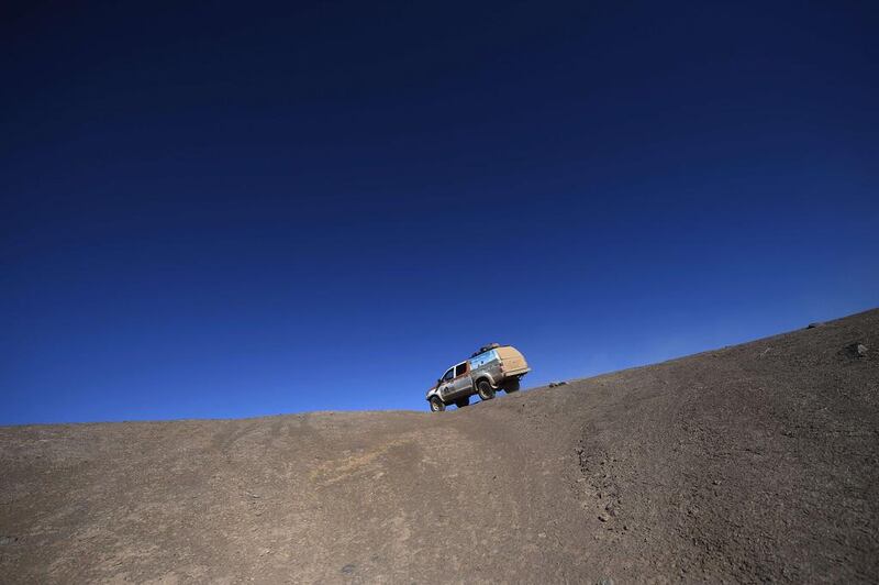 Dakar Rally director Etienne Lavigne, and staff members drive in Iquique on Saturday in Chile during the reconnaissance for the next Dakar 2015 that will kick off on January 4 in Buenos Aires, Argentina and will run untill January 17, after 9,000 kilometres through Argentina, Bolivia and Chile. Franck Fife / AFP / September 20, 2014