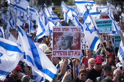 Protesters hold signs and flags during a demonstration calling for a hostage deal and denouncing Israeli Prime Minister Benjamin Netanyahu's government on May 20, 2024 in Jerusalem. Getty Images