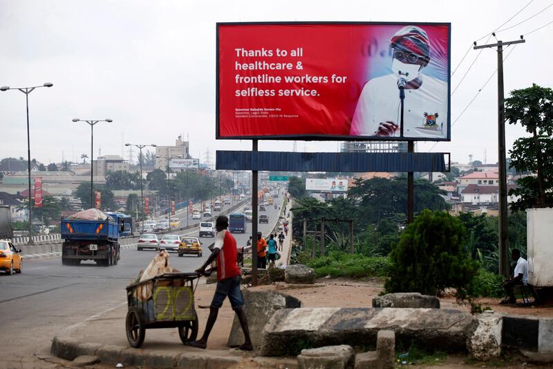A billboard campaigning for the prevention of the coronavirus is seen standing in a neigbourhood in Lagos. EPA