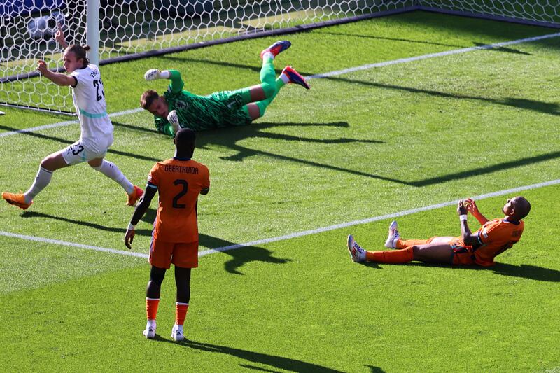 Donyell Malen, right, of the Netherlands reacts after scoring an own goal to give Austria their first goal. EPA