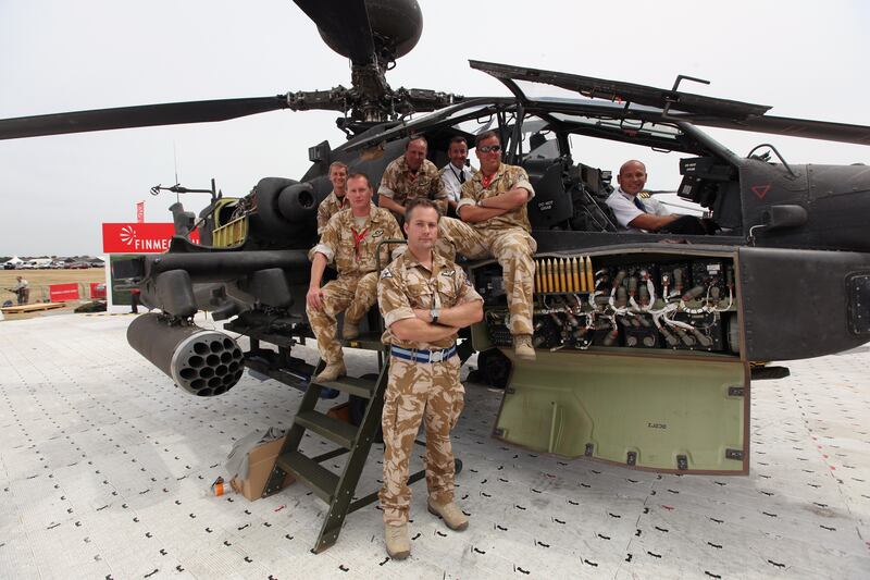 A crew from Wattisham army base in Suffolk with an Apache AH1 Helicopter at Farnborough Airshow in 2010.