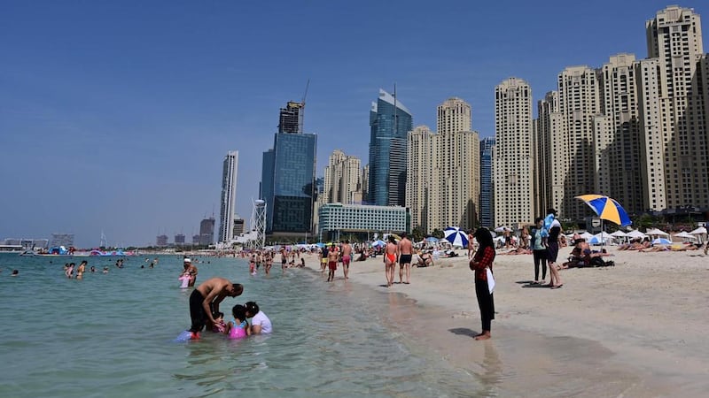 People swim at Jumeirah Beach residence in Dubai on Friday. Giuseppe Cacace / AFP