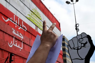 epa08398895 A protester flashes the victory sign during a protest at Al Nour Square in Tripoli, northern Lebanon, 03 May 2020. Anti-government protesters from across Lebanon arrived in the Lebanese city of Tripoli to show support of demonstrators of the city after the alleged death of a protester Fawaz Al Samman in clashes with the Lebanese army on 28 April 2020.  EPA/WAEL HAMZEH