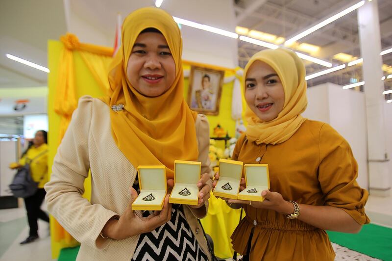 Muslim women pose with commemorative pins in Pattani province ahead of the coronation.  AFP
