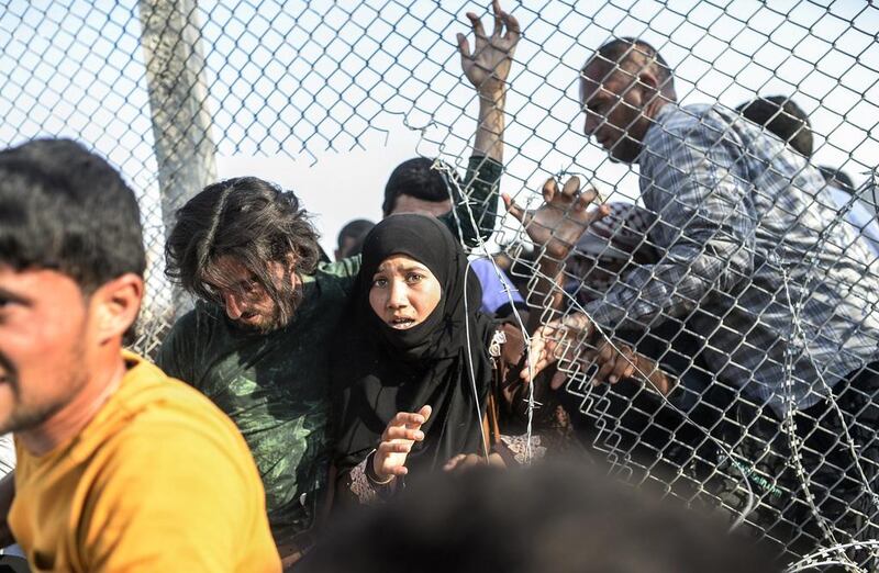 Before the border opened, there were chaotic scenes of refugees crossing the border illegally through holes in fences, prompting rapid intervention from the Turkish army. Bulent Kilic/AFP Photo