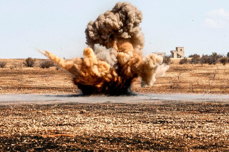 A landmine is remotely detonated in a field at a pistachio orchard in the village of Maan, north of Hama in west-central Syria.  AFP