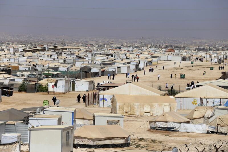 Syrian refugees walk at Zaatari refugee camp, in Mafraq, Jordan. Raad Adayleh / AP Photo