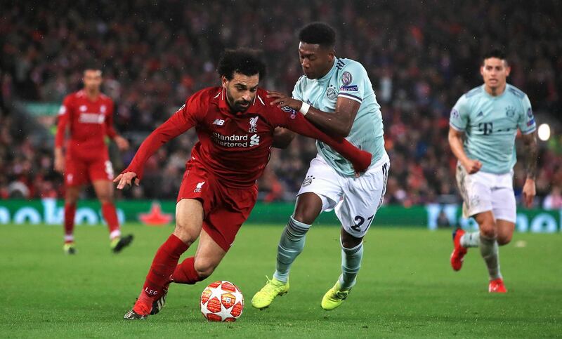 Liverpool's Mohamed Salah , left and Bayern Munich's David Alaba battle for the ball, during the Champions League round of 16 first leg soccer match between Liverpool and Bayern Munich,  at Anfield, in Liverpool, England, Tuesday, Feb. 19, 2019. (Peter Byrne/PA Wire/PA via AP)