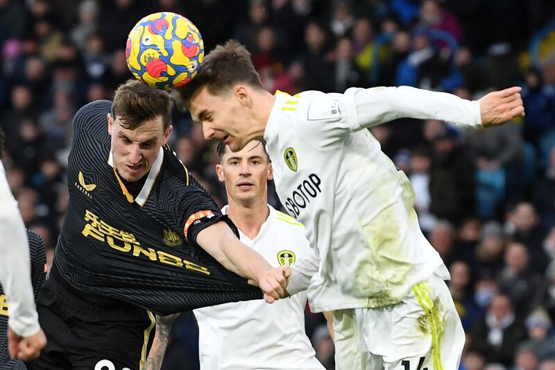 Newcastle's Chris Wood and Diego Llorente of Leeds challenge for a header. Reuters