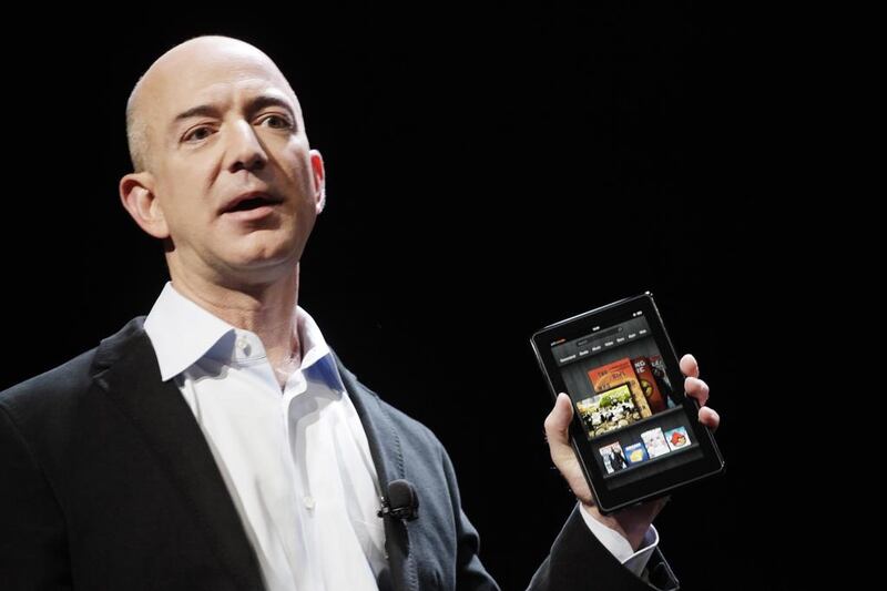 Amazon chief executive Jeff Bezos with the Amazon Kindle. Mark Lennihan/AP Photo