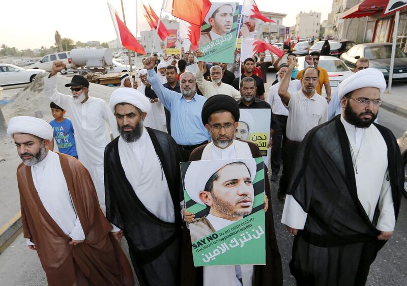 FILE PHOTO: Protesters hold photos of Sheikh Ali Salman, Bahrain's main opposition leader and Secretary-General of Al-Wefaq Islamic Society, as they march asking for his release in the village of Jidhafs, west of Manama, Bahrain June 16, 2015. Bahrain sentenced Salman to four years in jail on Tuesday on charges of inciting unrest, a decision that an opposition group said could stoke more protests in the Sunni Muslim-ruled kingdom. REUTERS/Hamad I Mohammed/File Photo