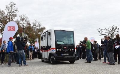 The first German autonomous public transport bus drives during a presentation in Bad Birnbach, southern Germany, on October 25, 2017. 
German state-owned rail company Deutsche Bahn unveiled its first-ever driverless bus Wednesday, saying the shuttle will bring passengers through a picturesque spa town to the train station. The first autonomous minibus can transport six passengers. It will travel on a partial public transport route of 700 meters in the small town of Bad Birnbach Lower Bavaria. / AFP PHOTO / Christof STACHE