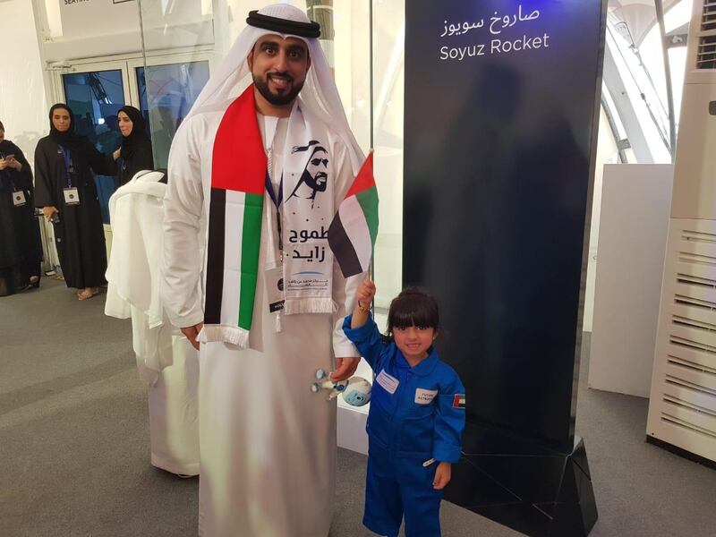 Hamad Al Blooshi, an engineer at Mohammed bin Rashid Space Centre, brings his daughter Maryam, 3, to watch the live stream of the launch, at MBRC in Dubai. Patrick Ryan / The National