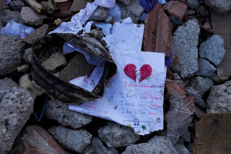 A sheet of paper lies among the rubble in Elbistan. AP