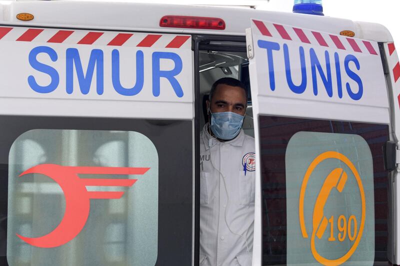 A paramedic rescuer of SAMU Tunisia looks out from the back of an ambulance in the capital Tunis. AFP