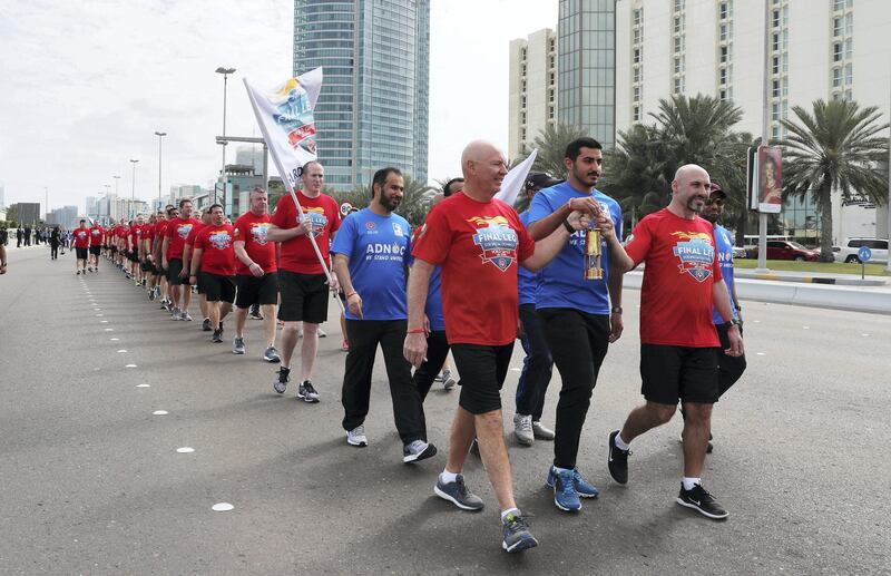 ABU DHABI , UNITED ARAB EMIRATES , March 3 – 2019 :- Officials carrying the ADNOC’s “Flame of Hope” to the Founder’s memorial in Abu Dhabi. ( Pawan Singh / The National ) For News/Online/Instagram/Big Picture. Story by John