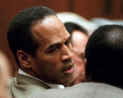 (FILES) In this file photo taken on February 15, 1995, double murder defendant OJ Simpson (L) talks to attorney Johnnie Cochran Jr., during testimony by a Los Angeles Detective Ron Phillips. Just days after the 25th anniversary of the gruesome double murder of which he was accused but acquitted, OJ Simpson has opened a Twitter account with a vow to do "a little getting even."
"Hey, Twitter world, this is yours truly," the former football star and actor says in a video that, for now, is his only post. Simpson's lawyer Malcolm LaVergne confirmed to CNN that the account was authentic, as was the video, apparently filmed by Simpson on a smartphone in the yard of a Las Vegas residence. / AFP / LEE CELANO
