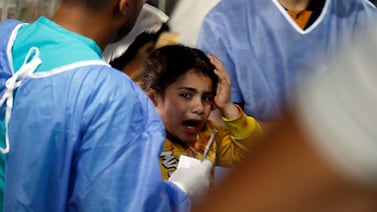Palestinian medics at Kuwaiti Hospital in Rafah refugee camp treat a girl injured in Israeli bombing on Tuesday. AP Photo