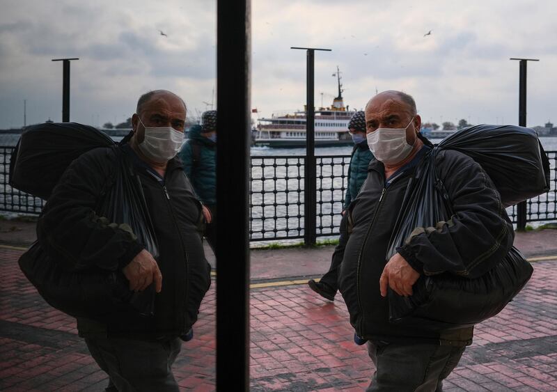 A man wearing face mask and carries his stuff as he arrive to the Asia side with ferry from Europe, amid the ongoing coronavirus pandemic in Istanbul, Turkey. Turkey will impose curfews on weekdays and full lockdowns over weekends to combat the spread of the coronavirus, President Tayyip Erdogan said on Monday, after new cases and deaths hit records highs in recent weeks.  EPA
