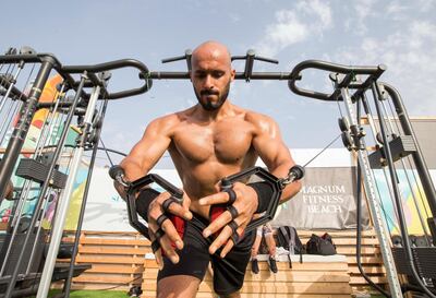 DUBAI, UNITED ARAB EMIRATES, 28 APRIL 2018 - A member of the gym exercising at Magnum Fitness open day at Kite Beach, Jumeirah Beach Road, Dubai. Leslie Pableo for The National for Haneen Dajani's story