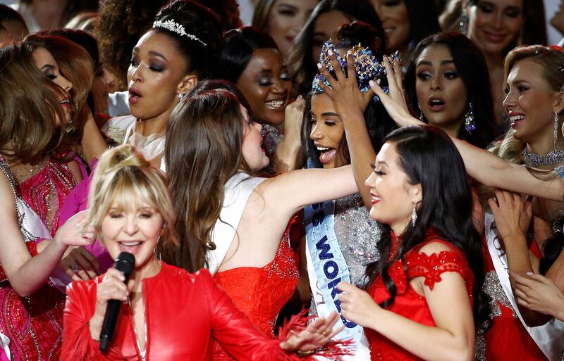 Singer LuLu performs as Miss World 2019 Toni Ann Singh of Jamaica celebrates. REUTERS