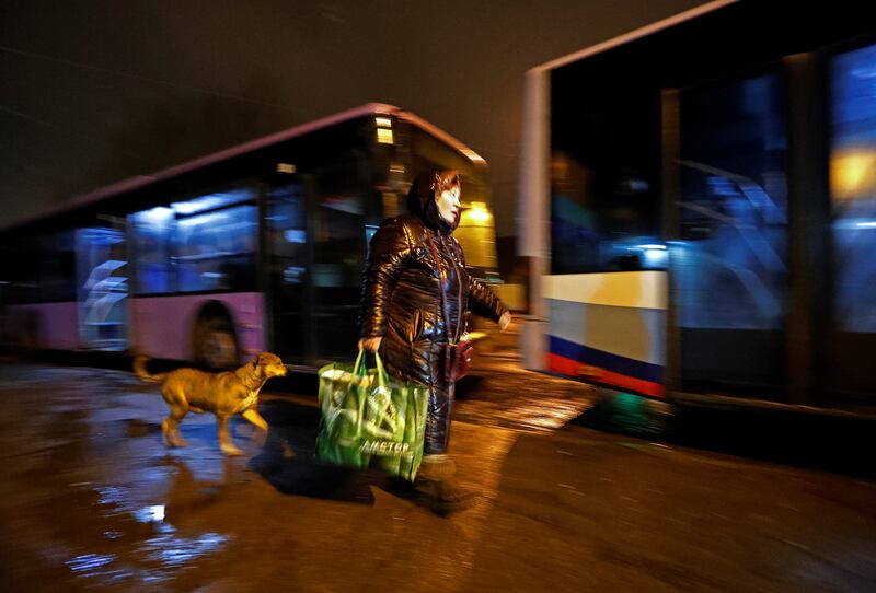 A woman walks to board a bus, arranged to evacuate local residents, in the rebel-controlled city of Donetsk, Ukraine. Reuters