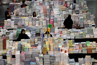 Visitors read books at the Big Bad Wolf Book Sale, which calls itself the world's biggest, hosted for the first time by Dubai, UAE October 17, 2018. Picture taken October 17, 2018. REUTERS/Satish Kumar