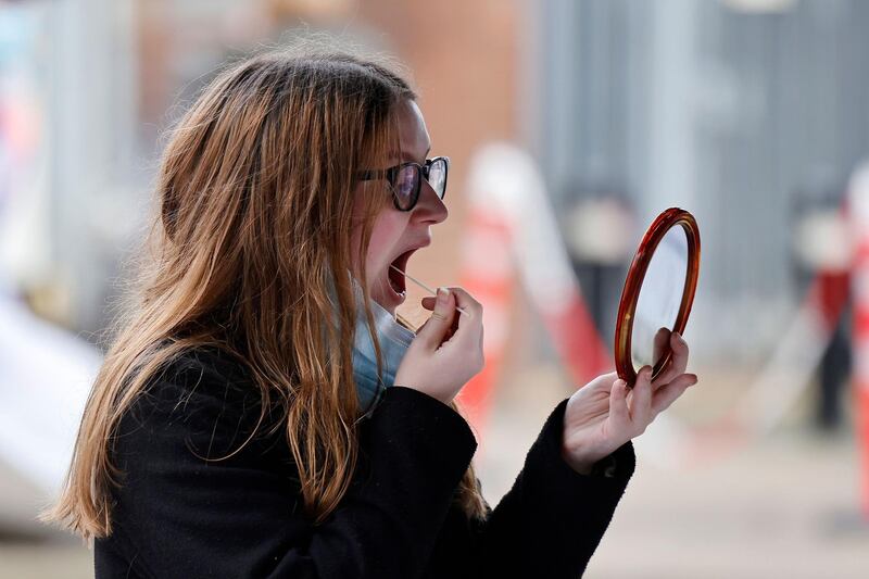 A member of the public takes a swab for a coronavirus test, part of surge testing for the South African variant of Covid-19, in West Ealing. AFP