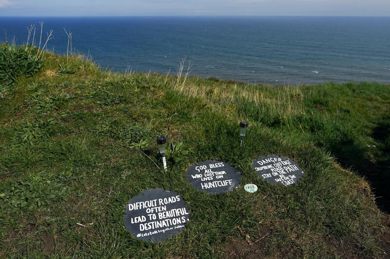 SALTBURN BY THE SEA, UNITED KINGDOM - MAY 01: Signs offering advice, reassurance and warnings are placed along a path that follows steep sea cliffs on the outskirts of Saltburn to support those who might be contemplating suicide on May 01, 2020 in Saltburn By The Sea, United Kingdom. The messages have been placed there by local man, Paul Waugh, a former Coastguard who has taken on the responsibility of trying to reduce the number of suicides along this stretch of sea cliffs. Increased social isolation, loneliness, health anxiety, economic pressures and stress are leading to increased concern for mental health issues during the Coronavirus pandemic. British Prime Minister Boris Johnson, who returned to Downing Street this week after recovering from Covid-19, said the country needed to continue its lockdown measures to avoid a second spike in infections. (Photo by Ian Forsyth/Getty Images)