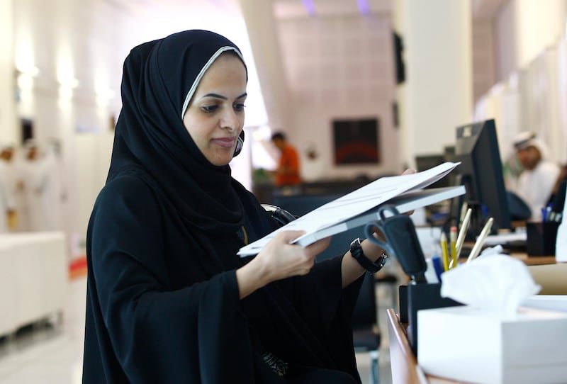 Dubai, United Arab Emirates, Aug 17 2011, FNC Register- Aisha Al Suwaidi checks her candidate package of documents.  Today was the last day to register for the FNC Election which will be held next month , Sept 2011. Candidates had present documentation and pay election fees. Mike Young / The National