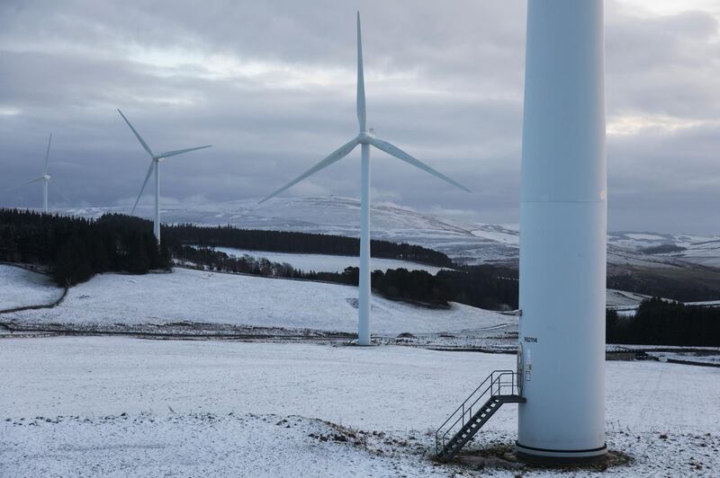 Wind turbines harnessing the natural green energy in the Scottish Borders on 28th December 2020 in Galashiels, Scotland, United Kingdom. The wind farm, Longpark Wind Farm, is long established and part of the renewable energy production in Scotland. The farm sits in the hills above the village Stow, near Galashields in the Scottish Borders. In between the wind turbines sheep grass in the fields lightly covered by snow. (photo by Kristian Buus/In Pictures via Getty Images)