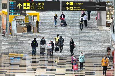 Travellers walk through the transit hall of Singapore Changi Airport on January 12, 2022. Photo: Roslan Rahman  /  AFP