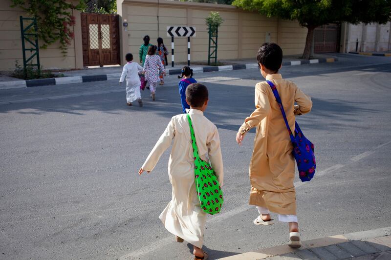 Sharjah, United Arab Emirates - June 23 2013 - Children participate in Hag El Leila, an Emirati tradition that occurs every year 15 days before the start of the month of Ramadan. The tradition involves children walking from door-to-door singing and collecting sweets and money. (Razan Alzayani / The National)  FOR RYM GHAZAL STORY  *** Local Caption ***  RA0623_hag_el_layla_009.jpg