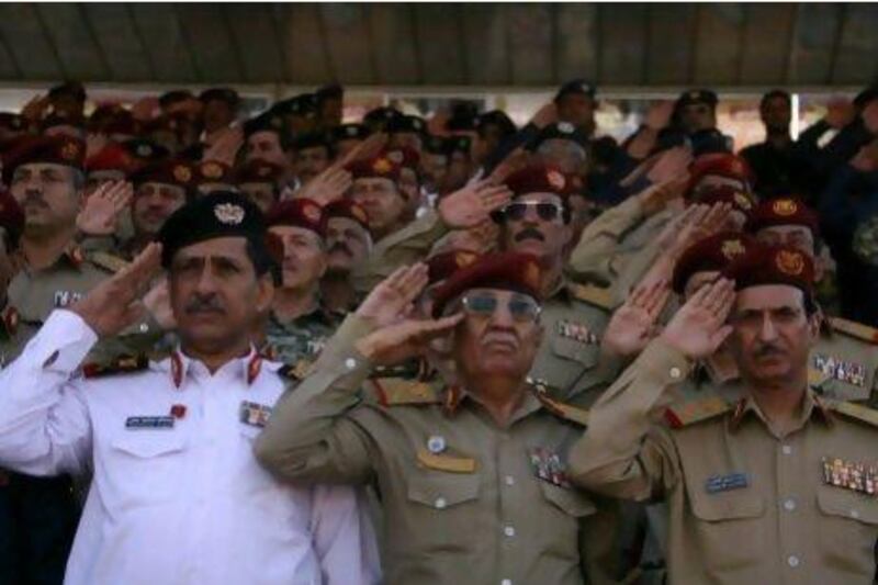 Yemeni army officers salute at the end of a sombre military parade marking the 22nd anniversary of Yemen's 1990 reunification in Sanaa today.