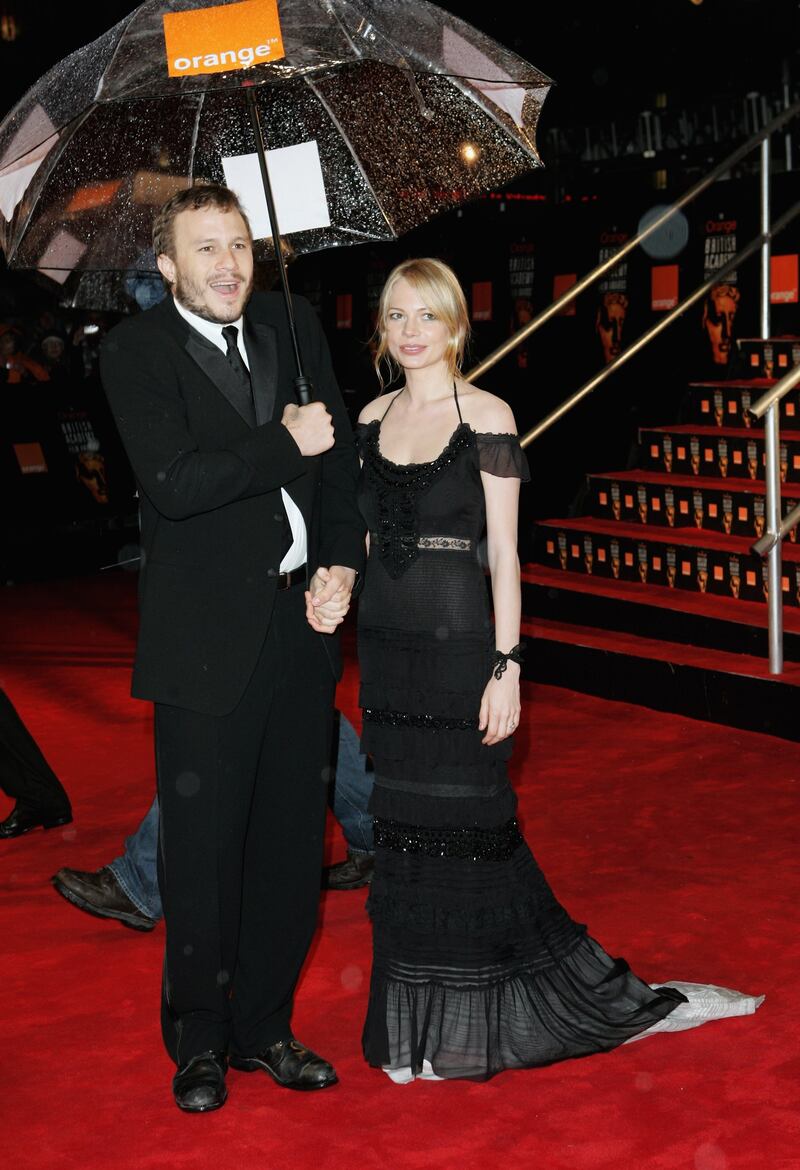 Michelle Williams, in an off-the-shoulder black dress, and Heath Ledger arrive at the British Academy Film Awards in London, England on February 19, 2006. Getty Images