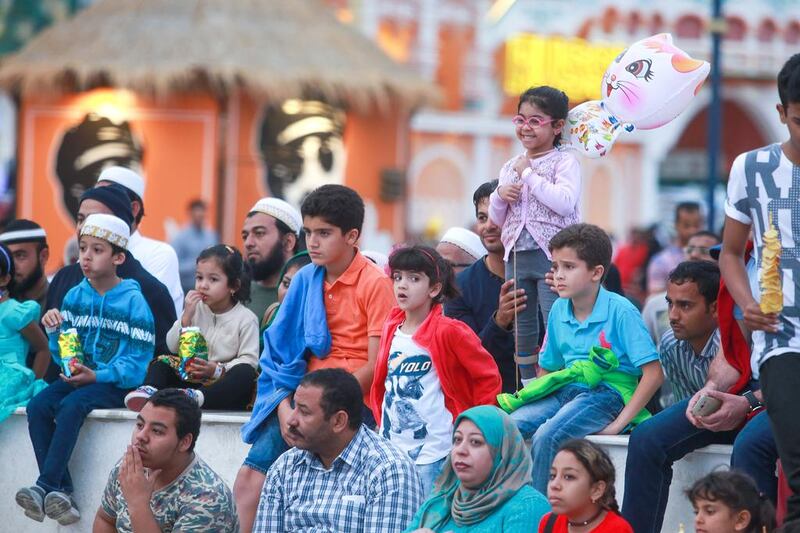 Dolphin Creative has 800 professional street performers from across the globe on its books. Above, an audience watches performances at Global Village in Dubai. Victor Besa for The National