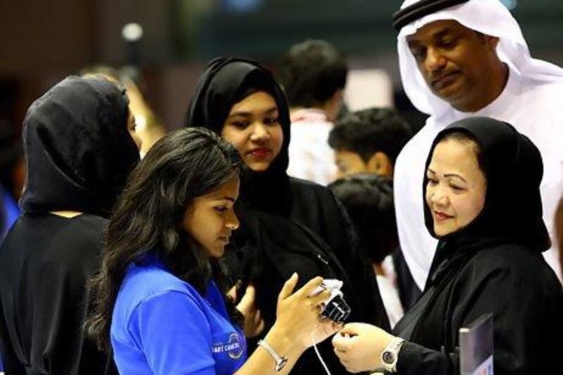 Visitors takes a closer look at Gitex Shopper in Dubai. Participating companies this year say they have high sales expectations. Satish Kumar / The National