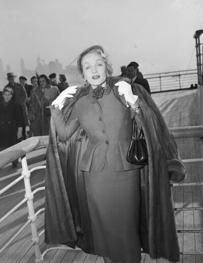 (Original Caption) 12/21/1950-New York, New York- Actress, Marlene Dietrich, unquestionably one of the most glamourous grandmothers in the world, shows herself to be little the worse for wear after her arrival at New York aboard the Queen Elizabeth. Getty Images

Marlene Dietrich wearing day suit by Christian Dior onboard the Queen Elizabeth arriving in New York, 21 December 1950. Getty Images