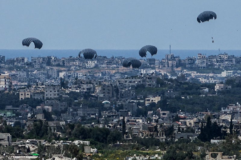 Parachutes drop supplies into the northern Gaza Strip as seen from southern Israel on Sunday, March 24, 2024. AP