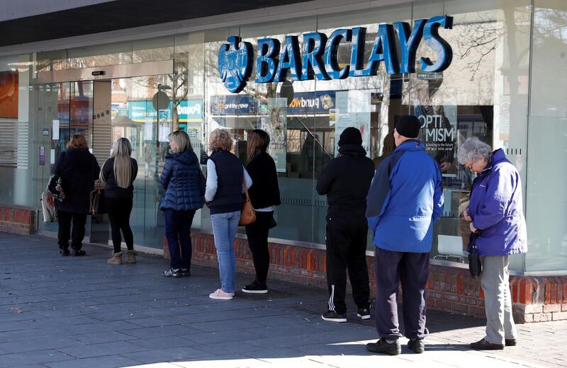 FILE PHOTO: People queue at Barclays Bank in St Albans, as the spread of the coronavirus disease (COVID-19) continues, in St Albans, Britain, March 23, 2020. REUTERS/Paul Childs/File Photo