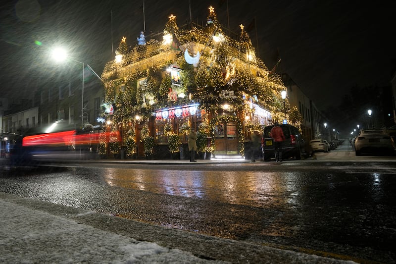 Snow outside the Churchill Arms pub in west London. AP